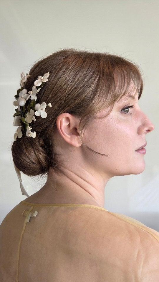 Bridal low bun finished with white flowers