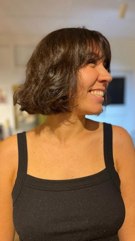 Short wavy brunette bob with a fringe